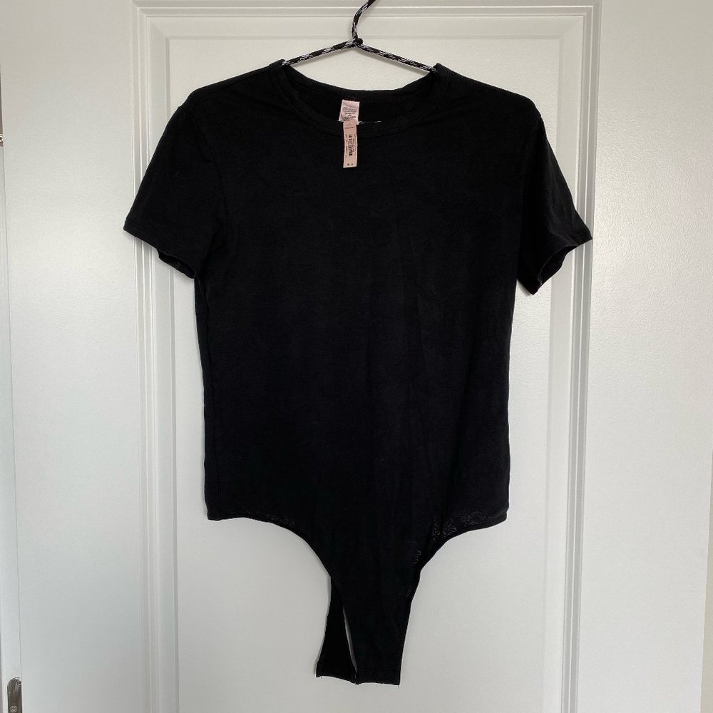 VS black short sleeve bodysuit with floral details
